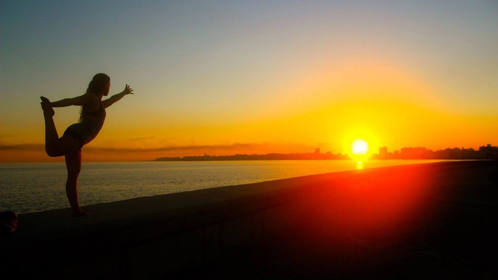 Yoga at sunrise on El Malecon in Havana, Cuba